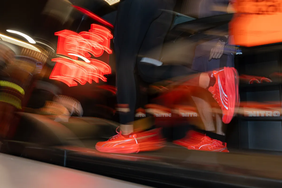 Motion blur of red Puma Nitro shoes on a treadmill